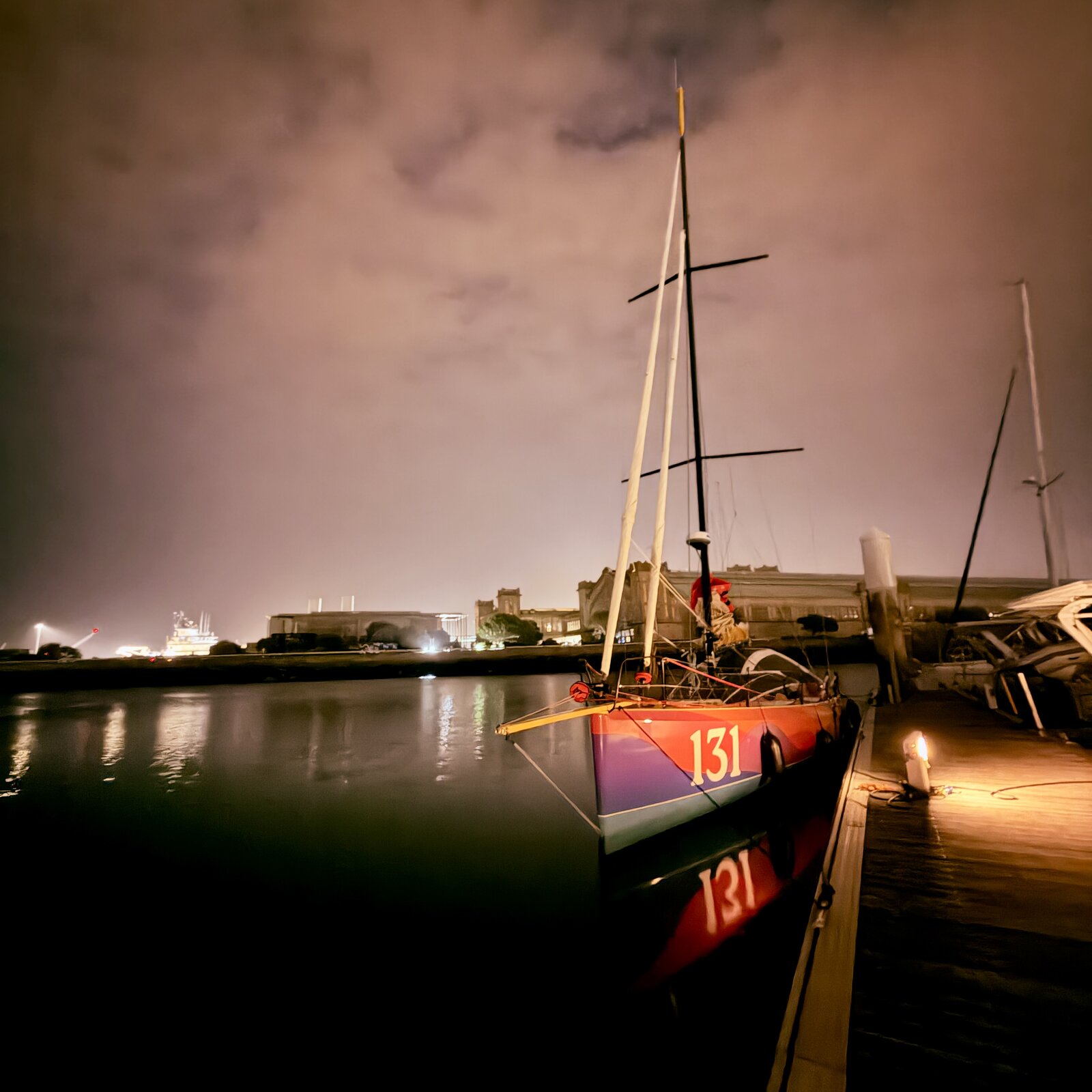 Guerrera dockside at night in Cherbourg, sail number 131 lit by dock lights