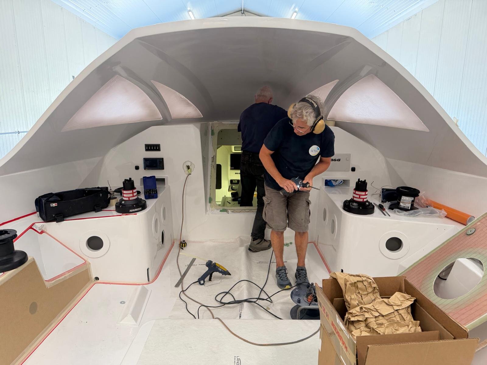 The nav station and cockpit interior being fitted with Harken winches and B&G electronics